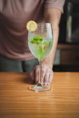Male bartender making a mojito cocktail.