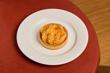An Exquisite and Delicious Peach Tart Served on a Beautiful White Plate for Your Enjoyment