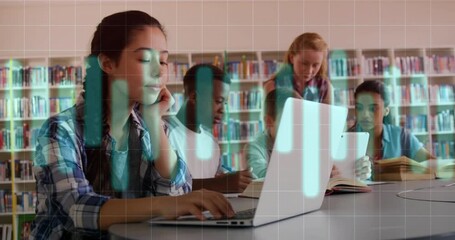 Teenage girl opening laptop initiating data overlay while students working on project in library - Powered by Adobe