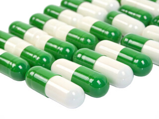 Green and white capsules in rows isolated on transparent background