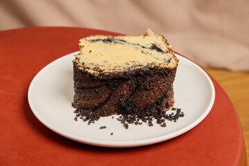A Delectable Slice of Chocolate Cake with Creamy Frosting Served on a White Plate