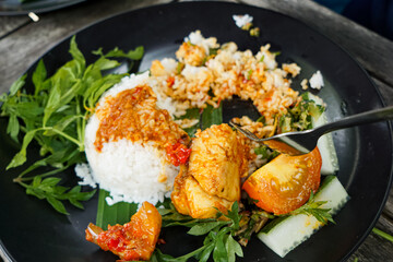 Malaysian style lunch called Nasi Campur. It is plain white rice served with protein, vegetable and other dishes