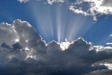 Sunbeams piercing dark clouds