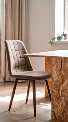A cozy dining space featuring a modern, upholstered chair with a checkered pattern and a unique table made of engineered wood.