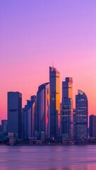 Obraz premium Modern city skyline at sunset with vibrant purple and pink sky