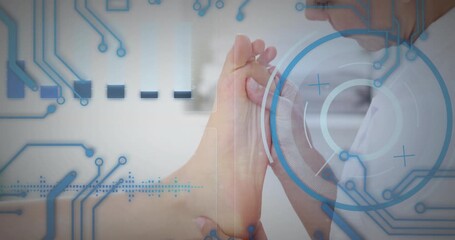 Rising HUD guiding therapist rotating and massaging foot on green towel while scanning for health