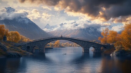 Stone arched bridge spans serene lake amid fall foliage and misty mountains under a dramatic, sunlit sky