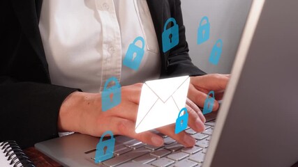 Email security. Close-up of an executive typing on her laptop, with an animation of an email envelope with several padlocks around it.