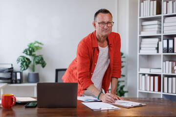 Obraz premium Man at work, Business man, startup and face with smile in modern office with confidence, pride and excited for career growth. finances and economy concept. 