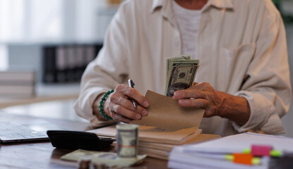 Asian male accountant or banker making money calculations. business man in workplace, Documents, tax, report for analysis Savings, finances and economy concept.