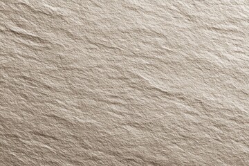 Close-up of beige textured paper surface with subtle creases