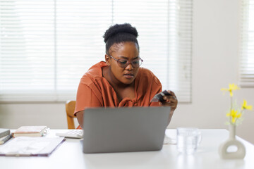 Unhappy woman feeling stressed calculating monthly expenses at home, facing financial problems or...