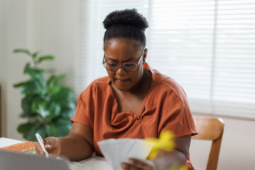 Unhappy woman feeling stressed calculating monthly expenses at home, facing financial problems or...