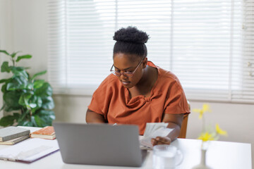 Unhappy woman feeling stressed calculating monthly expenses at home, facing financial problems or...