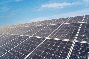 Large-scale solar panel array under clear blue sky