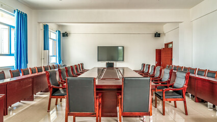 A spacious conference room with long table and chairs
