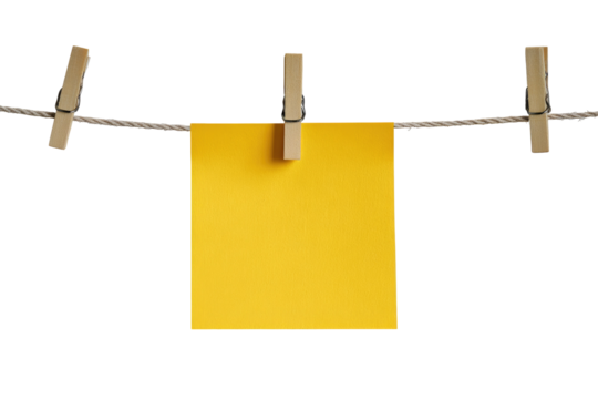 A bright yellow sticky note hangs from a clothesline. Wooden clothespins hold the note. Simple, neutral background