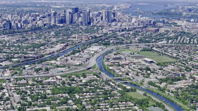 Aerial view of Verdun neighbourhood, Lachine Canal and Montreal downtown skyline in summer. g.