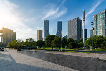Modern city skyline with tall buildings and open plaza
