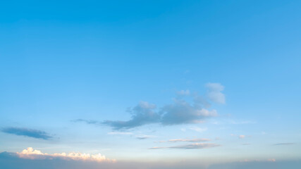 Clear blue sky with a few scattered clouds in the distance