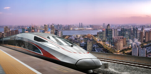 High-speed train running through urban landscape with modern cityscape in background