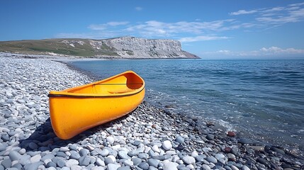 Yellow canoe on pebble beach near cliffs.