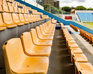 Yellow chairs lined up in the stands of the football stadium in the city of São Luis, state of...
