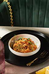 Rizo pasta with tomato sauce, bright lighting, in an overhead restaurant composition