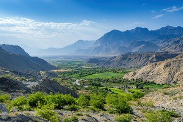 Obraz premium Lush green valley with distant mountains 