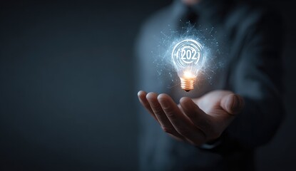 A hand holds a glowing lightbulb, digitally enhanced with a circular graphic and numbers, set against a dark background