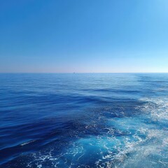 Fototapeta premium Vast expanse of deep blue ocean under a clear sky