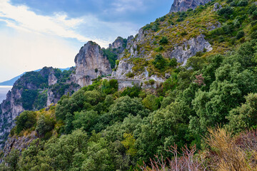 Fototapeta premium Rocky Coastline Greenery, Mountain Road, Blue Sky Scenery