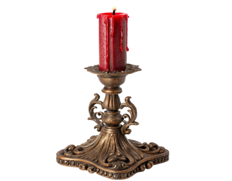 Elegant vintage brass candle holder with red wax candle on black background isolated in dim light