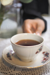 Warm tea served in delicate cup during cozy gathering