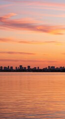 Fototapeta premium City skyline at sunset over calm water cityscape dusk