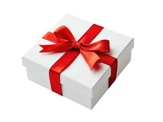 Obraz premium A white gift box, adorned with a vibrant red ribbon and bow, sits angled on a plain background