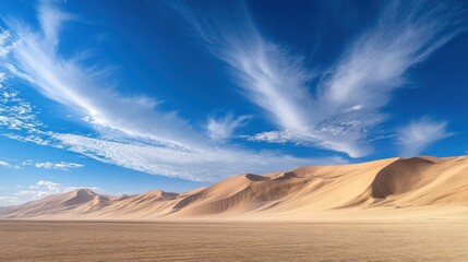 Expansive desert landscape with rolling sand dunes under a vibrant blue sky with wispy cloud formations above