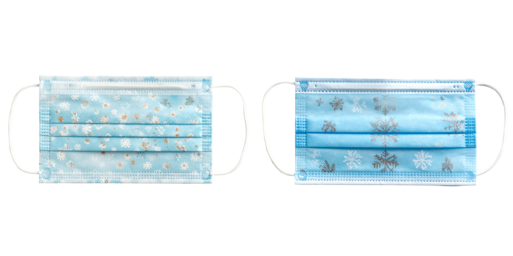 Two Blue Medical Masks with Snowflake and Decorative Pattern Against Transparent Background
