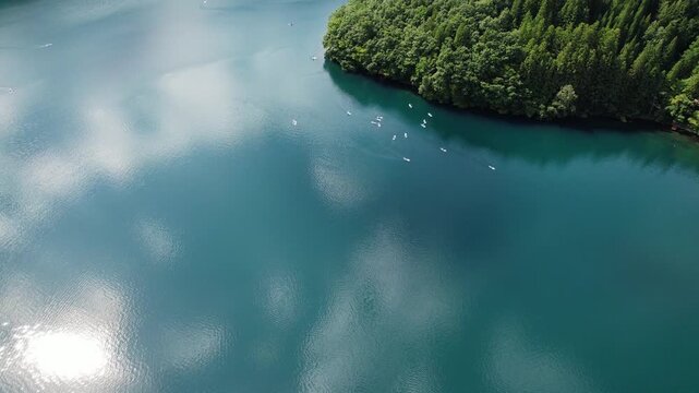Tourists Standup Paddleboarding In Summertime At Lake Aoki In Omachi City, Nagano Prefecture, Japan. Aerial Drone Shot