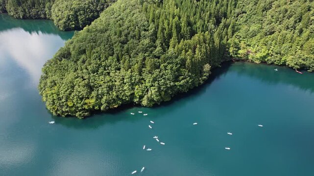 Stand-up Paddle Boards Across The Placid Waters Of Lake Aoki In Omachi City, Nagano Prefecture, Japan. Aerial Drone Shot