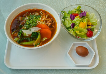 delicious Asian food, beef noodle and fresh salad