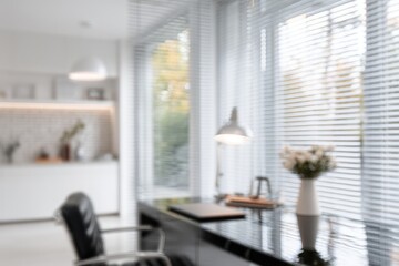 Blurred modern workspace with window view
