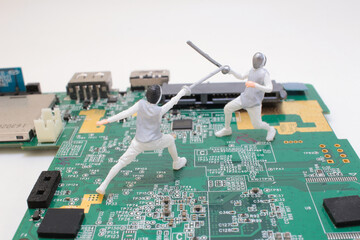 Miniature Fencing Figures Battling on a Computer Circuit Board Surface