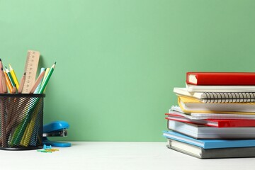 A back to school concept featuring various school supplies and notebooks