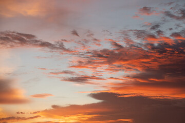 Dramatic sunset sky with vivid orange and purple clouds, creating a peaceful and romantic atmosphere. Perfect for backgrounds, travel themes, and inspirational designs.