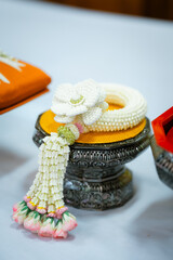 A close-up shot of a beautifully crafted Thai traditional offering, showcasing its intricate details and vibrant colors. The details are sharp and the colors are vivid.