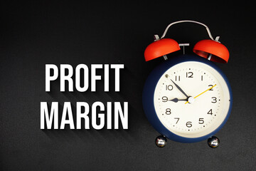Profit Margin text with alarm clock on black background