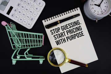 Stop Guessing. Start Pricing With Purpose text written on notepad with alarm clock and trolley...
