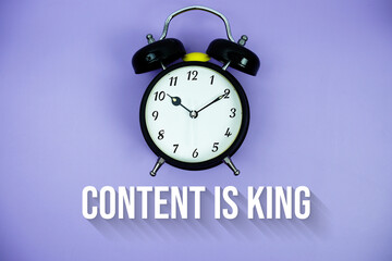Content Is King text and alarm clock on purple background