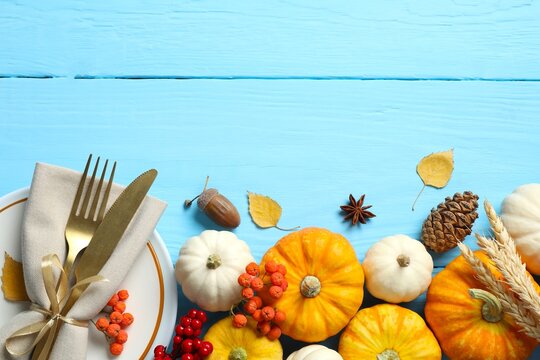 Rustic holiday table setup. Top view with plates, cutlery and autumn decorations. The concept of Halloween, Thanksgiving or other autumn holidays. Empty space for your text 